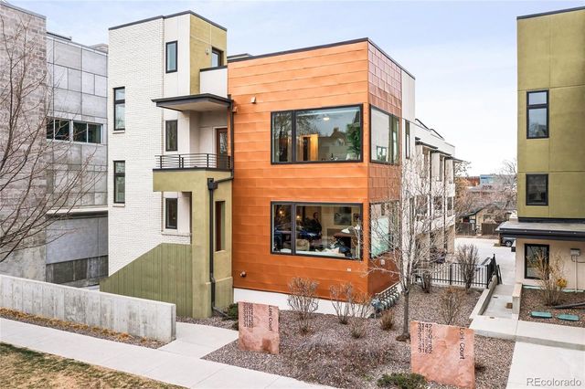a front view of a house with large windows