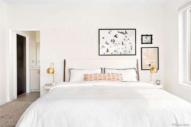 a bedroom with a bed and a large mirror