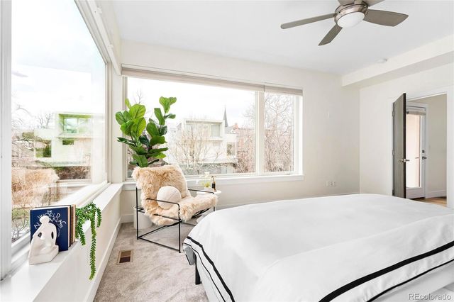 a bedroom with a bed and a large window