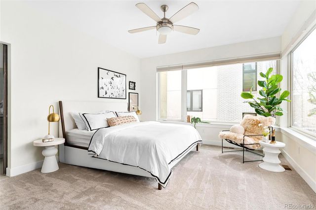 a bedroom with a bed couch and window