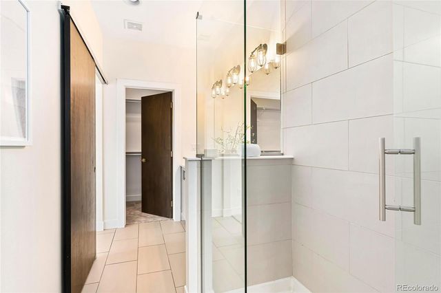 a bathroom with a shower and a glass door