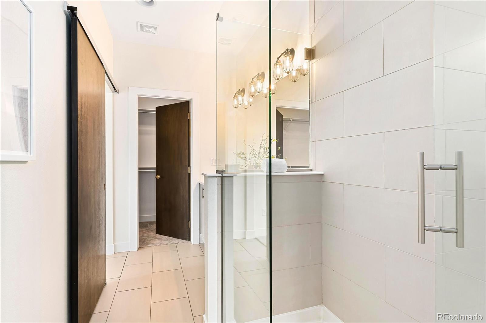 3166 Vallejo Street Denver, CO 80211 - Photo 28 of 50 a bathroom with a shower and a glass door