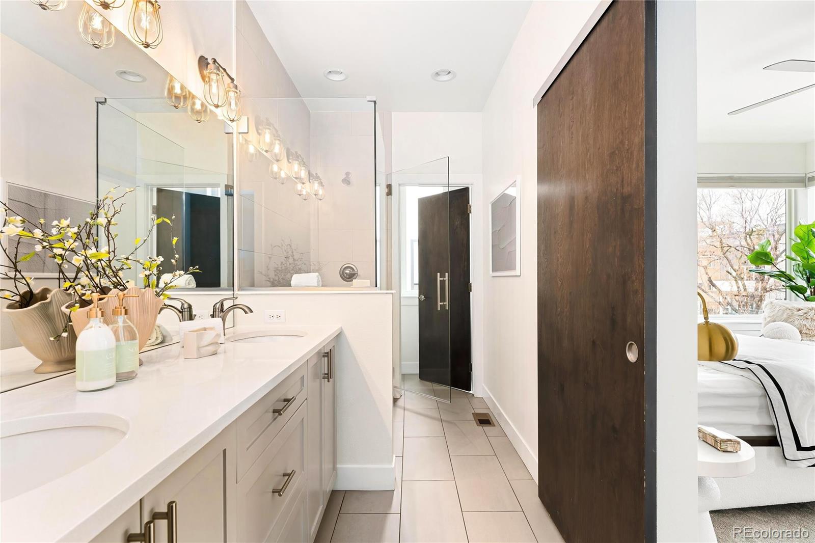 3166 Vallejo Street Denver, CO 80211 - Photo 29 of 50 a bathroom with a double vanity sink and mirror