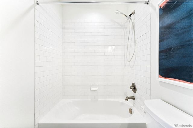 a bathroom with a bathtub and shower