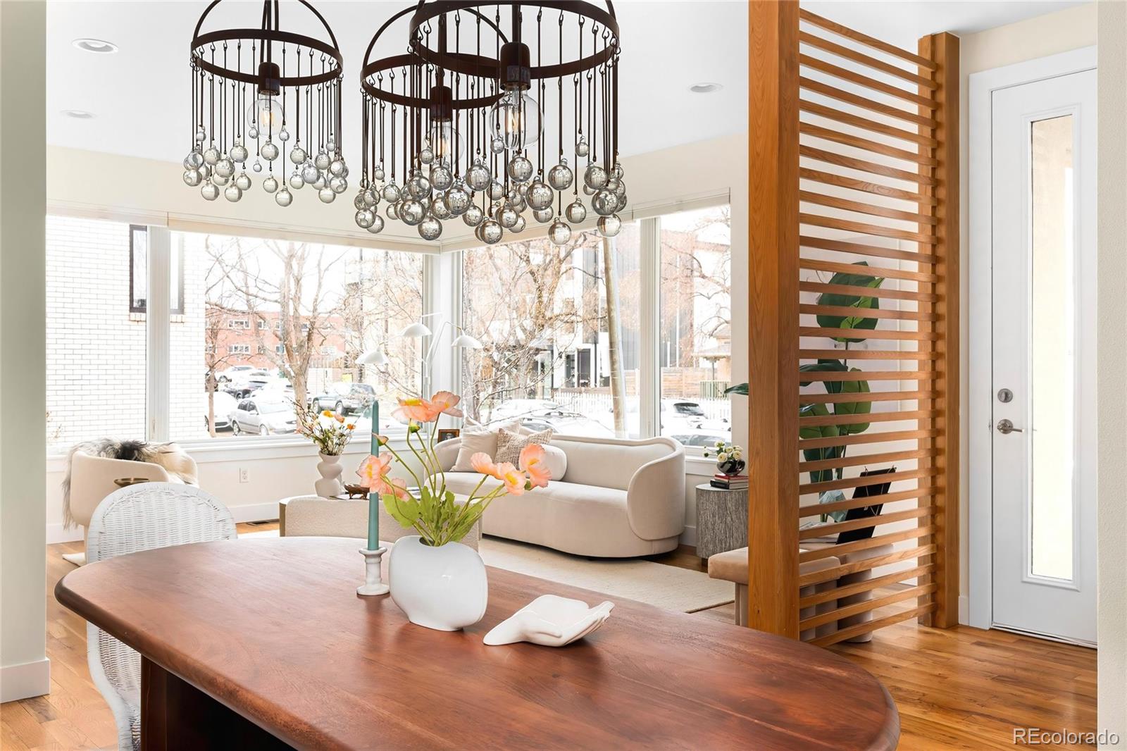 3166 Vallejo Street Denver, CO 80211 - Photo 5 of 50 a dining room with furniture a chandelier and wooden floor