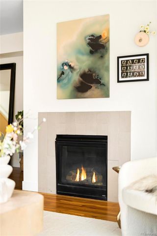 a living room with a fireplace and a wooden floor