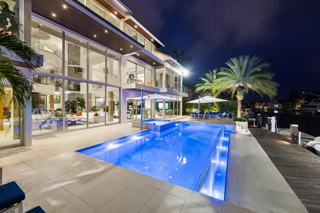 a swimming pool with outdoor seating and yard