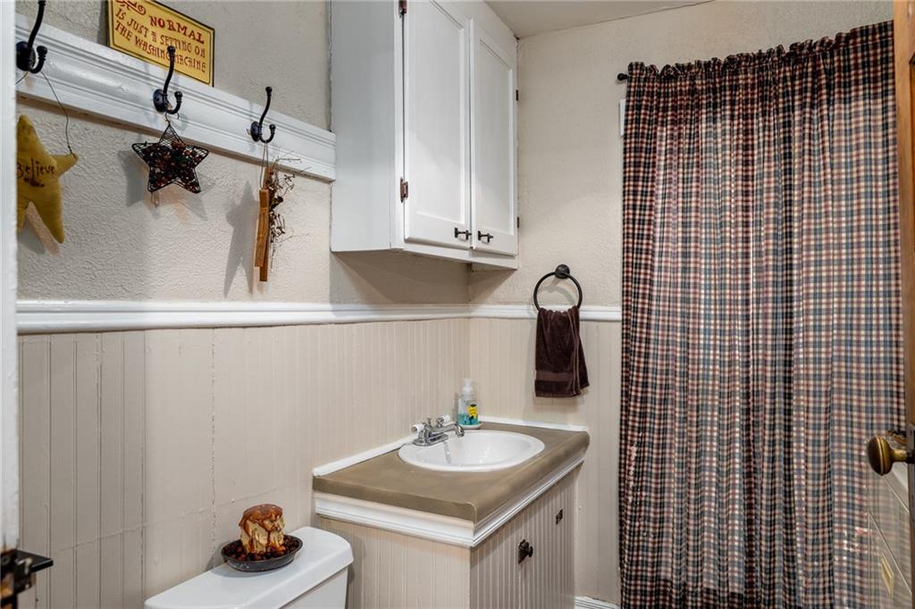 4 North Liberty Road West Alexander, PA 15376 - Photo 6 of 15 The main floor bathroom with laundry area is an added convenience off the kitchen