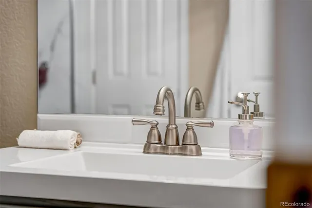 a bathroom with a granite countertop sink toilet a shower and a mirror