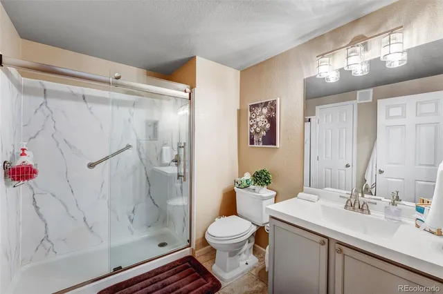 a bedroom with a bed closet and flat tv screen