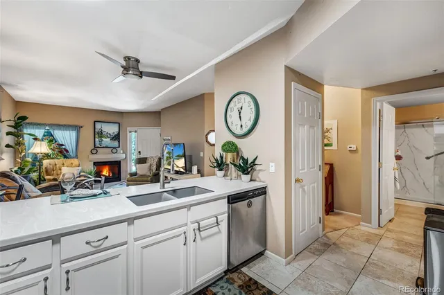 a sink with a vase and flowers on it