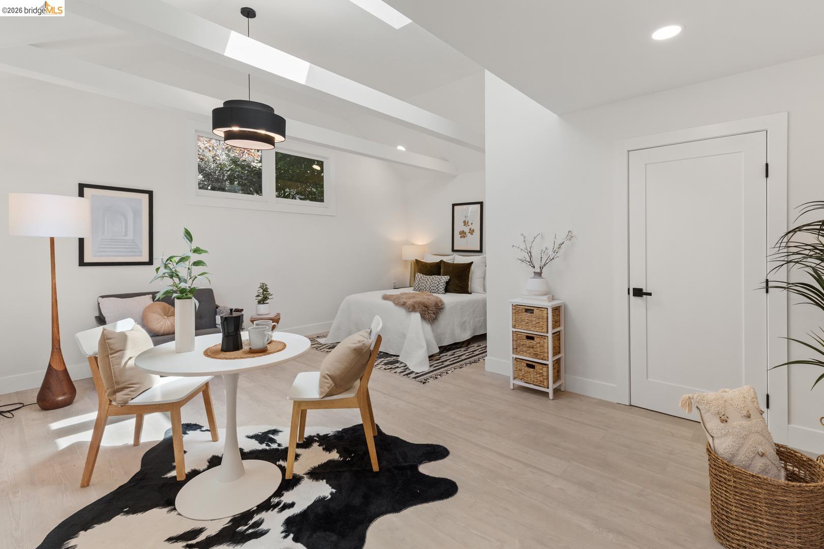 25 Stonewall Road Berkeley, CA 94705 - Photo 45 of 52 Open-concept living area with light wood-finish flooring, recessed lighting, and a modern tiered pendant light fixture