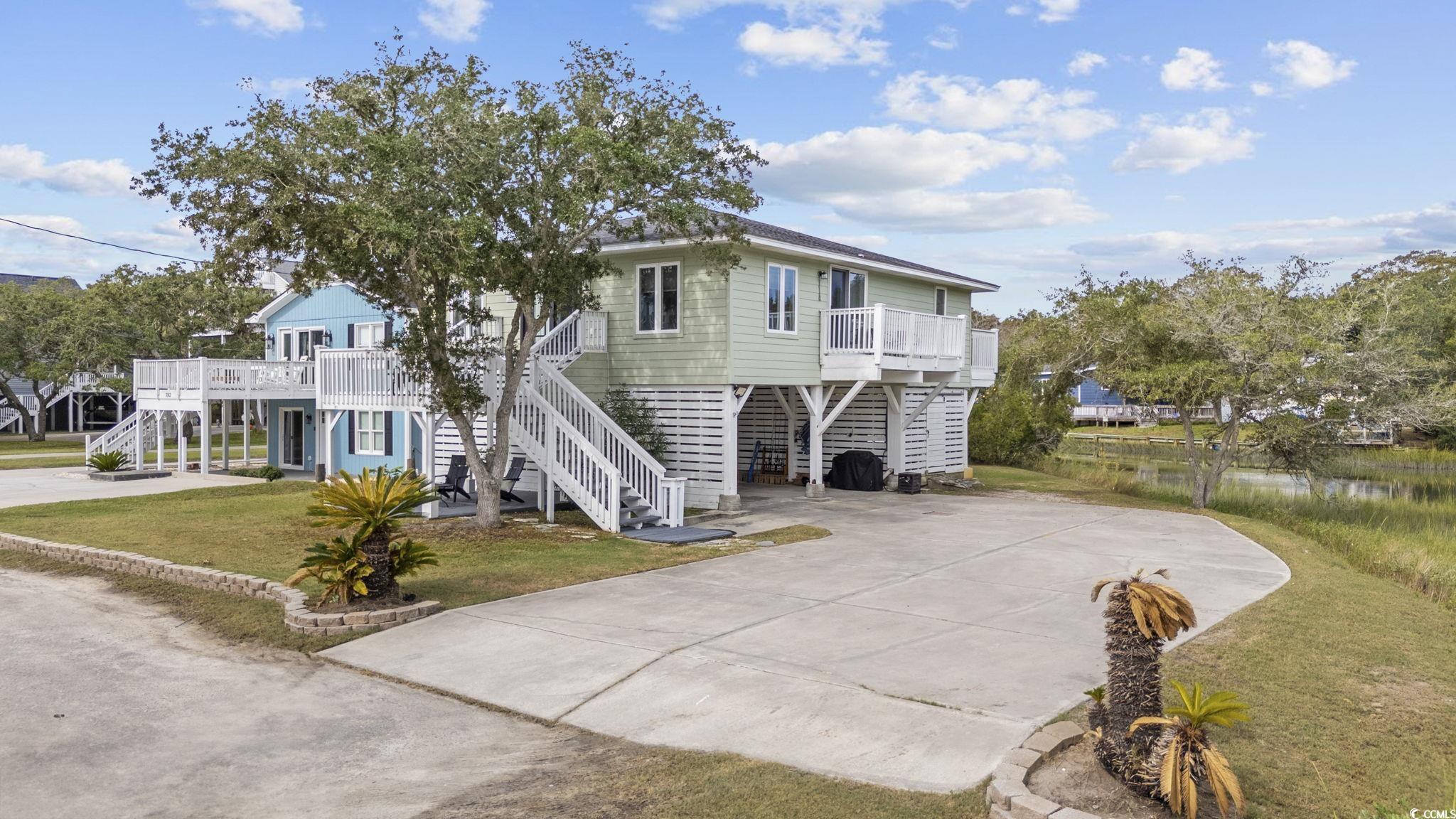 3184 State Rd S-26-816 Murrells Inlet, SC 29576 - Photo 2 of 40 Coastal inspired home featuring a front yard