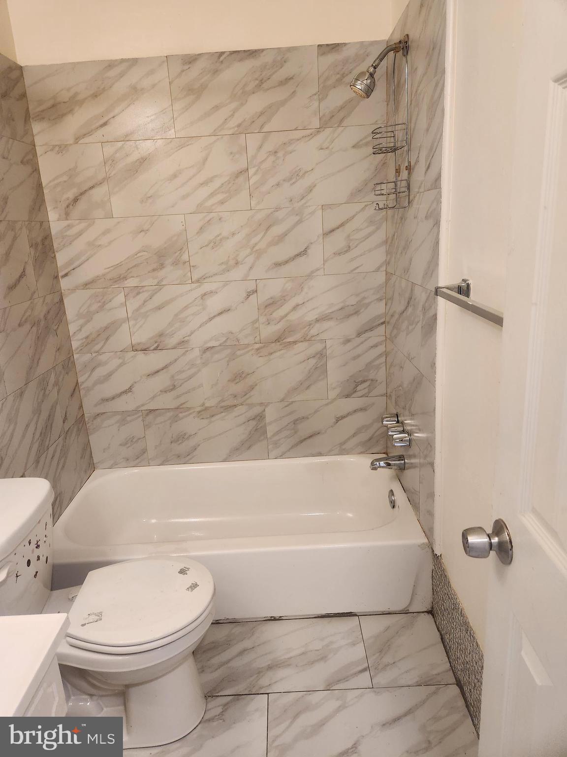 4320 Howell Street, Unit 1 Philadelphia, PA 19135 - Photo 13 of 19 a bathroom with a toilet and a bath tub