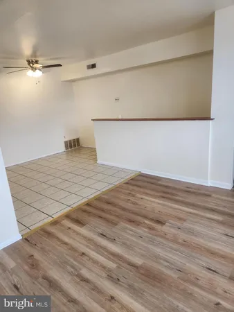 a view of a room with wooden floor