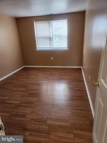 a view of wooden floor and windows in a room