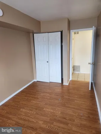 a view of wooden floor and windows in a room