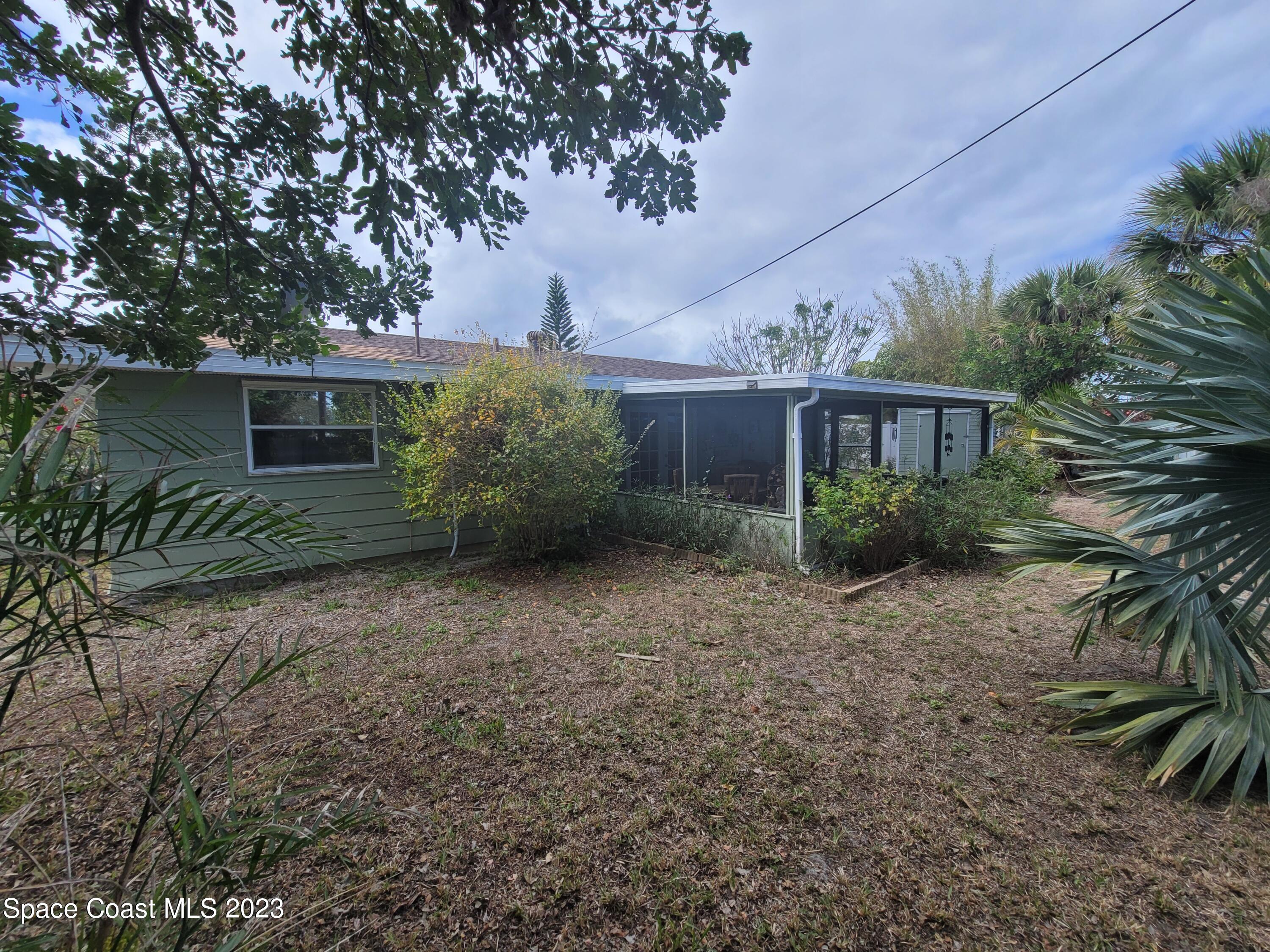 1107 Cable Lane Northeast Palm Bay, FL 32905 - Photo 16 of 17 a view of house with large trees and front area