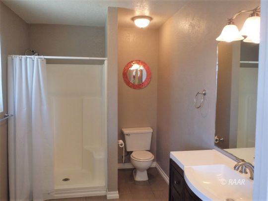 633 South Gemstone Street Ridgecrest, CA 93555 - Photo 24 of 35 a bathroom with a toilet a sink and vanity