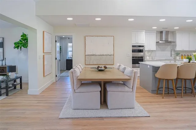 a view of kitchen with cabinets table and chairs