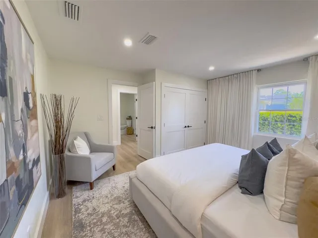 a spacious bedroom with a bed and a couch