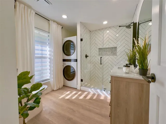 a bathroom with a sink a mirror and shower