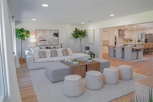 a living room with furniture and kitchen view