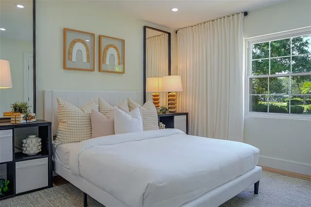 a bedroom with a bed and a window