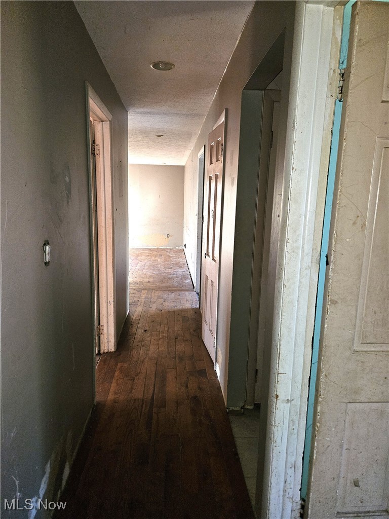 16940 Thompson Road Thompson, OH 44086 - Photo 11 of 30 Hallway featuring dark wood-style flooring