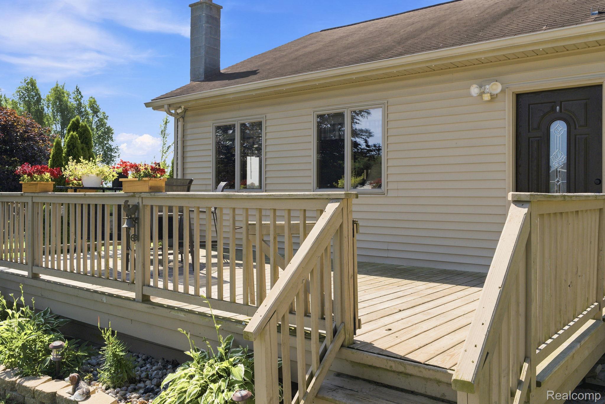 4201 Galbraith Line Road Croswell, MI 48422 - Photo 32 of 39 Spacious outdoor deck with natural wood railing and stairs
