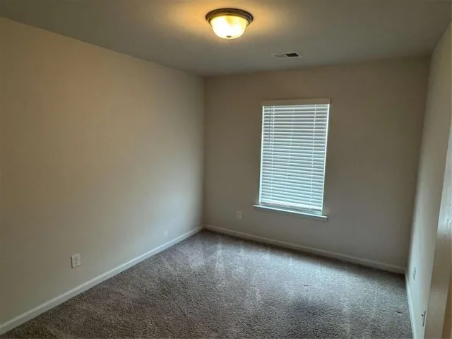 an empty room with closet area