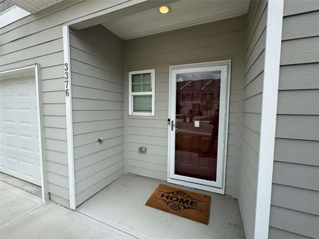 an open kitchen with wooden floor and large window