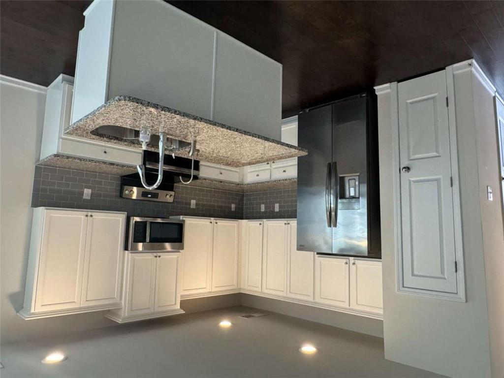 3376 Highbury Way Stonecrest, GA 30038 - Photo 6 of 28 a kitchen with stainless steel appliances granite countertop a refrigerator a sink a stove a microwave and wooden cabinets