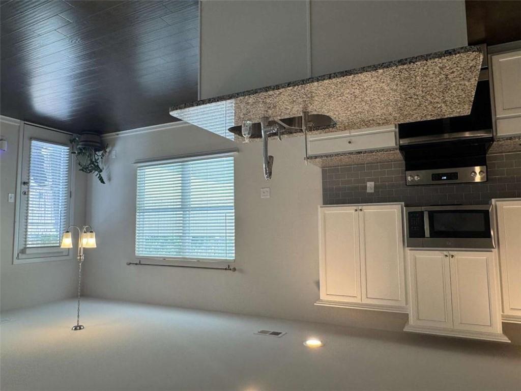 3376 Highbury Way Stonecrest, GA 30038 - Photo 7 of 28 a kitchen with granite countertop a sink a stove cabinets and a granite counter tops