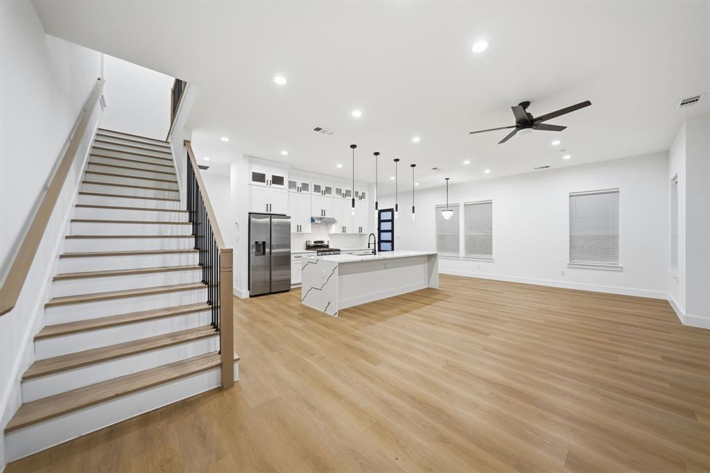 306 East 7th Street Dallas, TX 75203 - Photo 12 of 22 Spacious open-concept interior featuring light wood-finish flooring