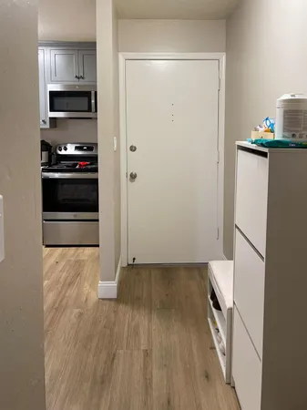 a kitchen with a refrigerator and a stove top oven