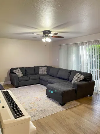 a living room with furniture and a chandelier