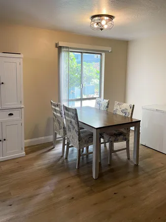 a view of a dining room with furniture window and wooden floor