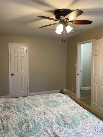 a view of a livingroom with a chandelier fan and closet