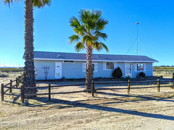 a view of a house with wooden fence