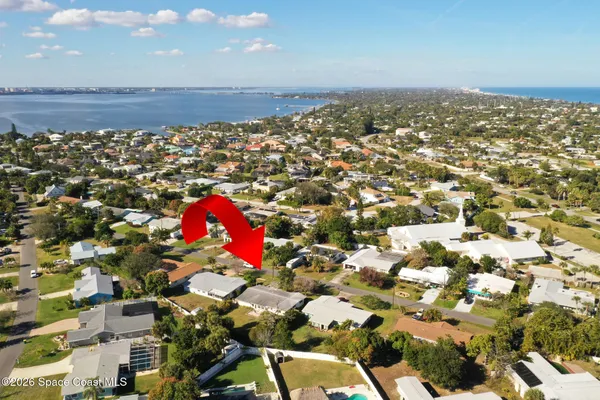 an aerial view of a houses with yard
