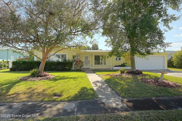 a view of a house with swimming pool and a yard