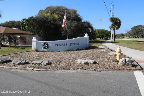 a view of a sign of a park next to a road