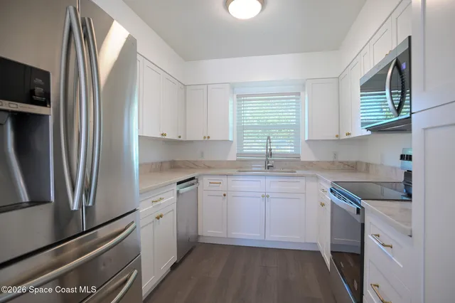 a kitchen with a sink stove and refrigerator