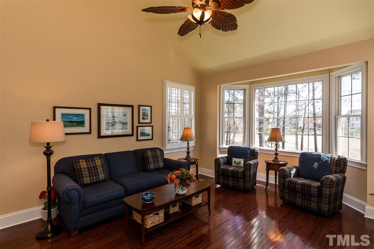 9124 Palm Bay Circle Raleigh, NC 27617 - Photo 11 of 24 a living room with furniture large window and wooden floor