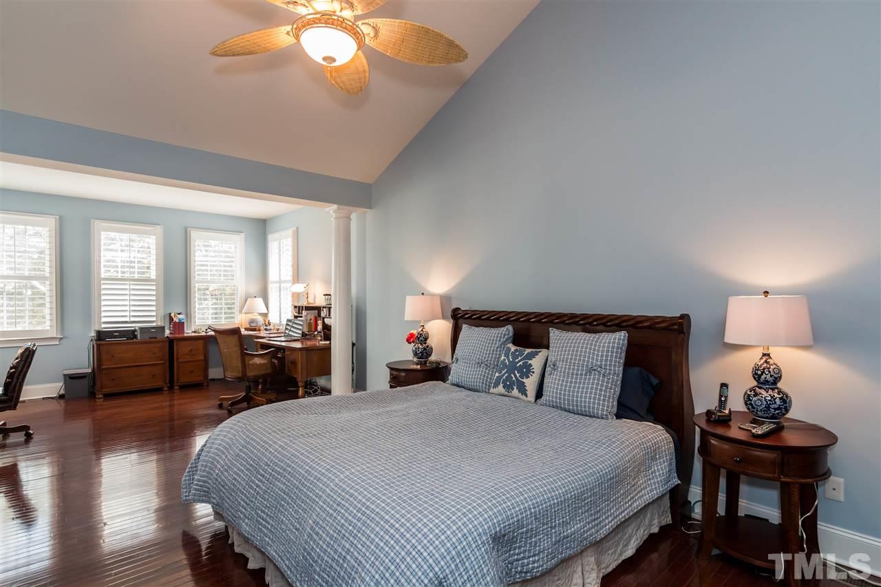 9124 Palm Bay Circle Raleigh, NC 27617 - Photo 12 of 24 a bedroom with a bed and wooden floor