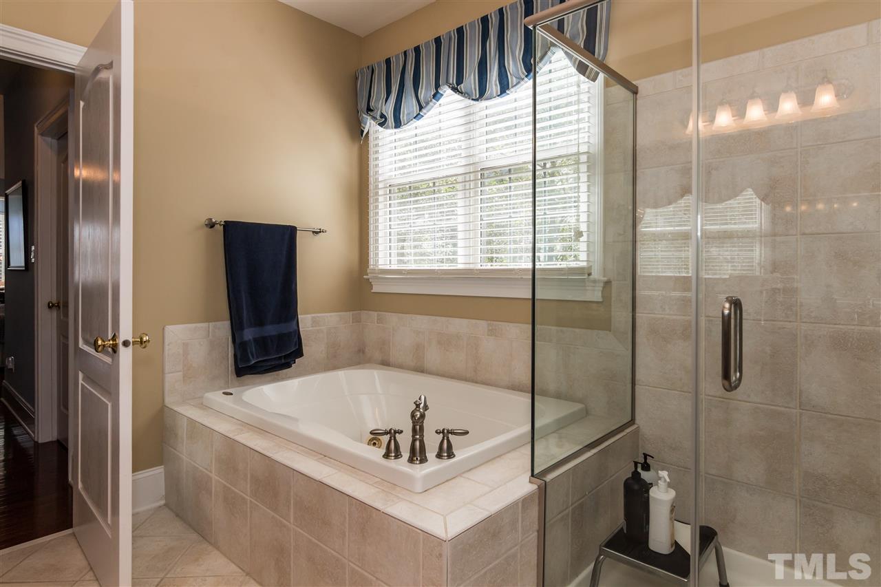 9124 Palm Bay Circle Raleigh, NC 27617 - Photo 13 of 24 a bathroom with a tub and a shower