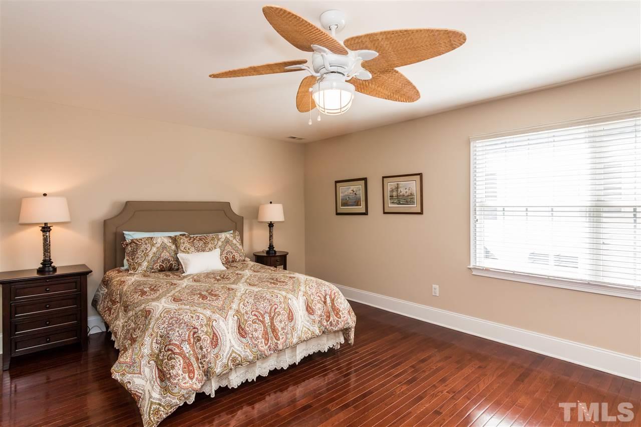 9124 Palm Bay Circle Raleigh, NC 27617 - Photo 15 of 24 a bedroom with a bed and wooden floor