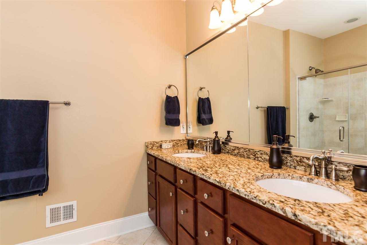 9124 Palm Bay Circle Raleigh, NC 27617 - Photo 16 of 24 a bathroom with double vanity and a mirror