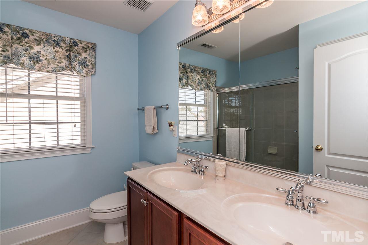 9124 Palm Bay Circle Raleigh, NC 27617 - Photo 18 of 24 a bathroom with a granite countertop sink toilet and mirror